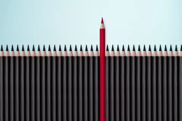 Xgraphicstock red pencil standing out from crowd of plenty identical black fellows.jpg