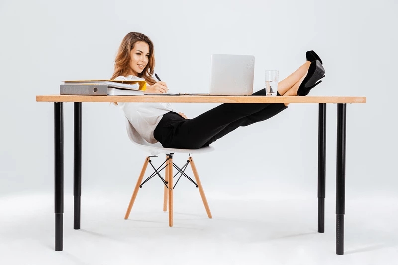 Xgraphicstock smiling young businesswoman using laptop and writing with legs on table over white background BObYukFH3e.png.pagespeed.ic .QBhO J9g8y